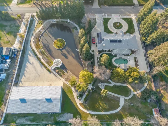 a view of a house with swimming pool and a yard