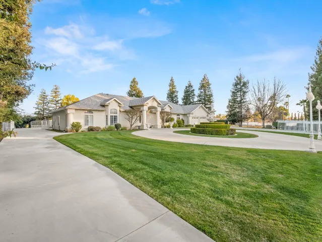 a living room with furniture kitchen view and a chandelier