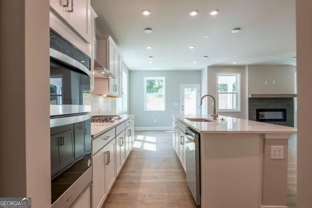 a kitchen with stainless steel appliances granite countertop a stove and a sink
