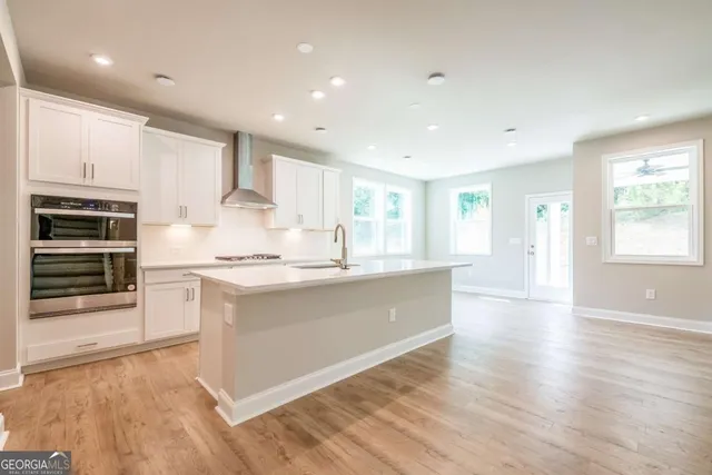 a kitchen with stainless steel appliances granite countertop a stove a sink and a refrigerator