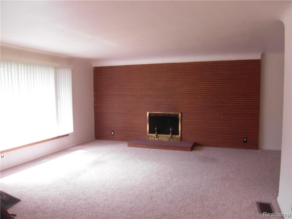 Large living room window and fireplace wall. 