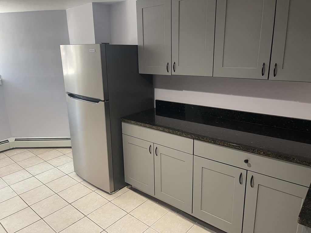 23 Spring Street, Unit B Malden, MA 02148 - Photo 6 of 9 a kitchen with appliances and cabinets