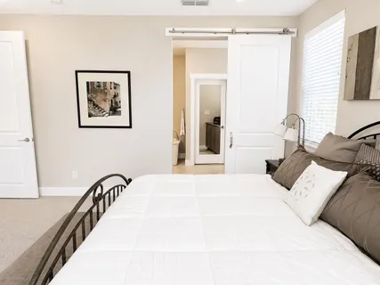 a bedroom with a bed and a flat screen tv