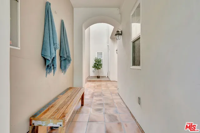 a bedroom with a bed and large window