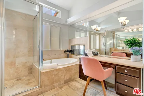 a bedroom with a bed and a chair