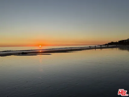 a view of a balcony with wooden chairs