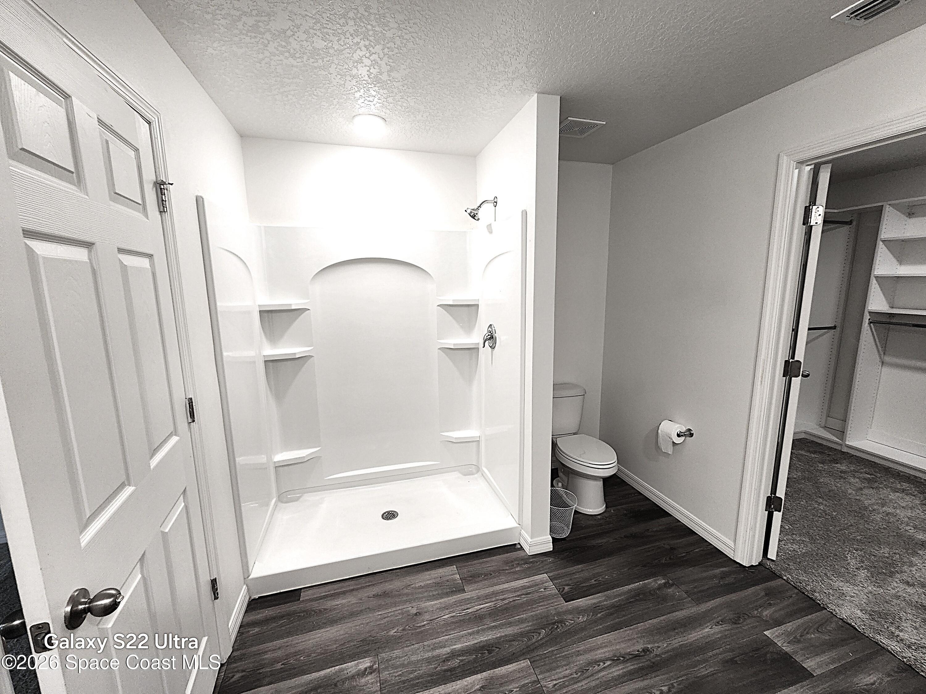 1043 Corbin Circle Southwest Palm Bay, FL 32908 - Photo 14 of 18 a bathroom with a glass door shower and toilet