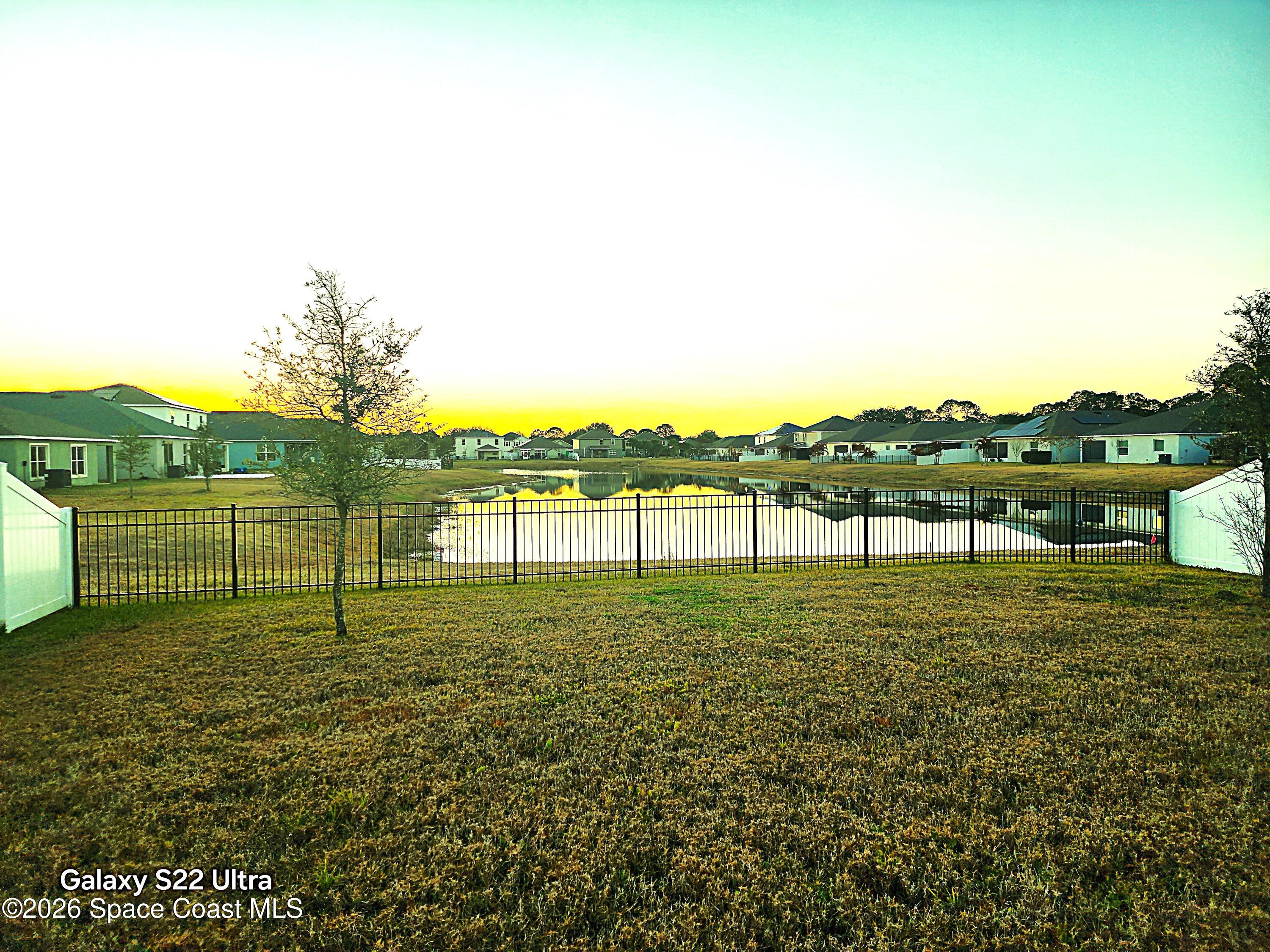 1043 Corbin Circle Southwest Palm Bay, FL 32908 - Photo 4 of 18 a view of a lake with houses