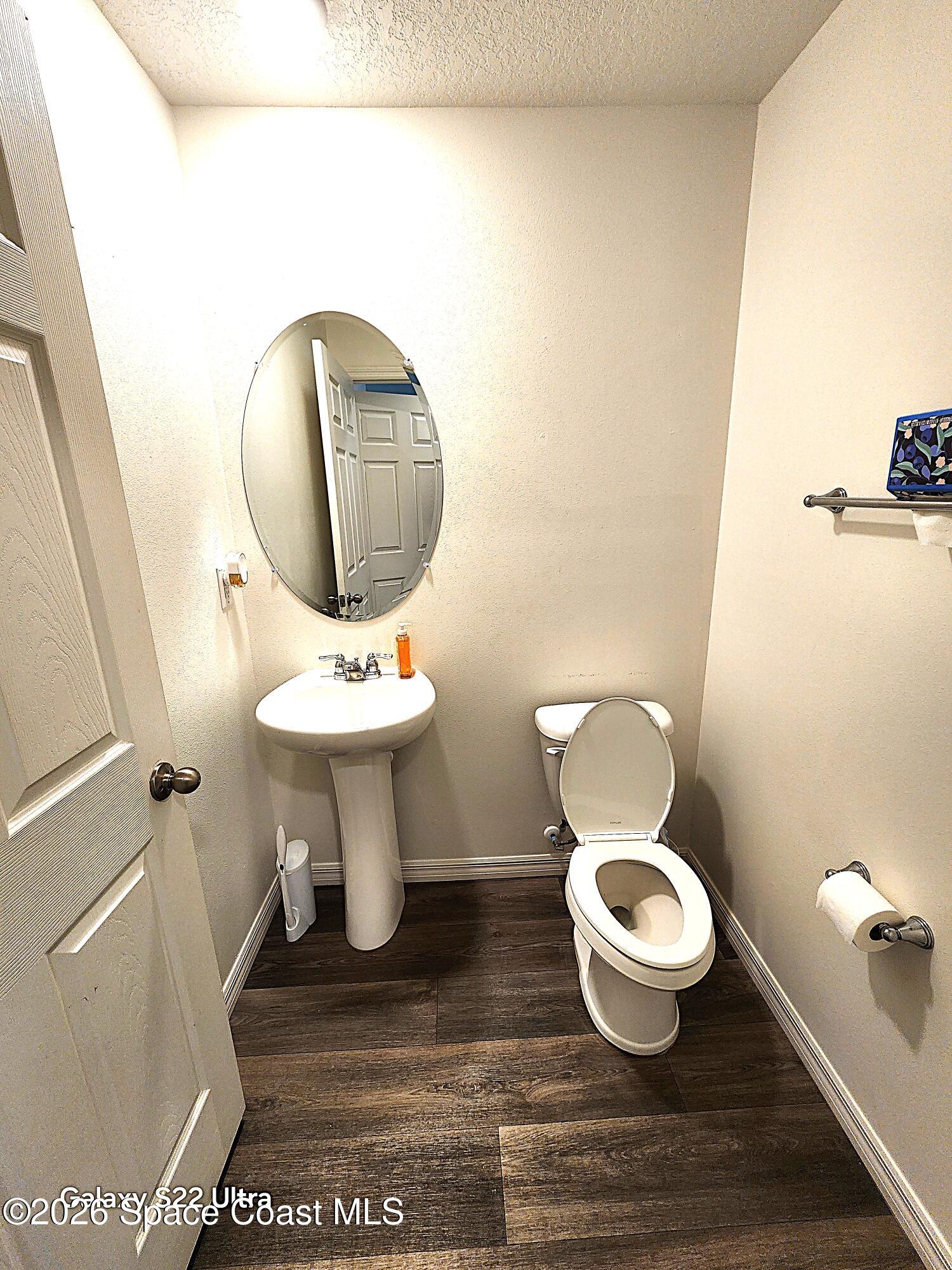 1043 Corbin Circle Southwest Palm Bay, FL 32908 - Photo 8 of 18 a bathroom with a toilet and a sink