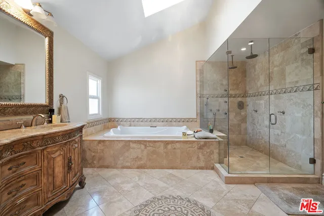 a bathroom with a granite countertop bathtub shower sink and mirror