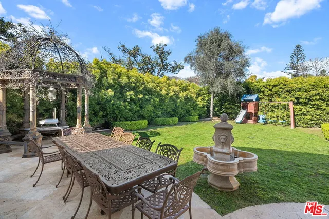 a view of an outdoor space with garden and patio