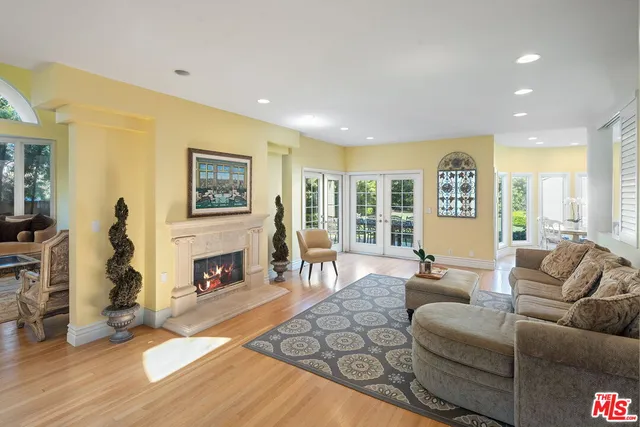 a living room with furniture large window and a fireplace