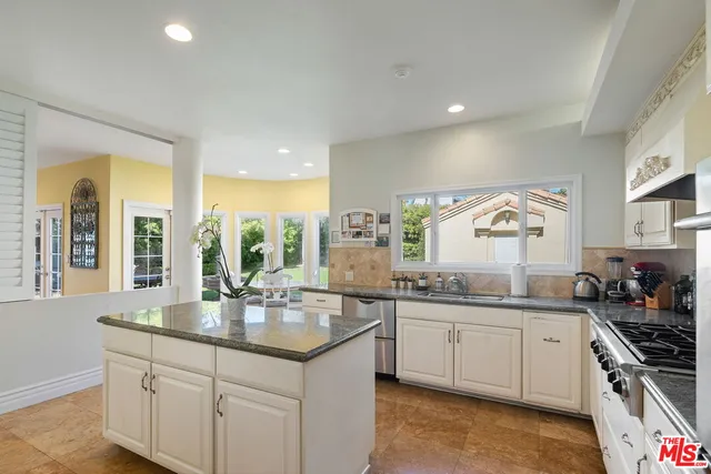 a kitchen with counter top space sink and stove