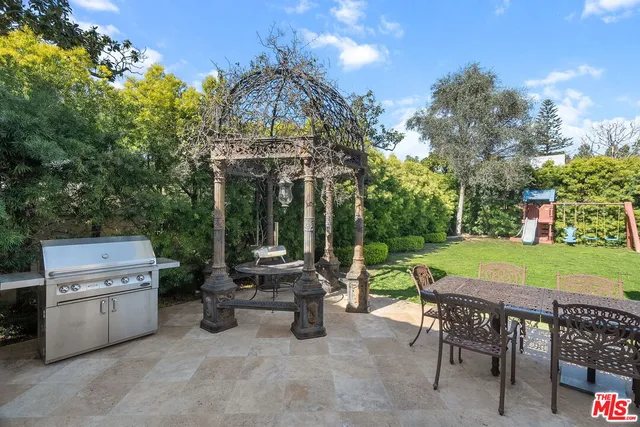 a view of a patio with a table chairs and a fire pit