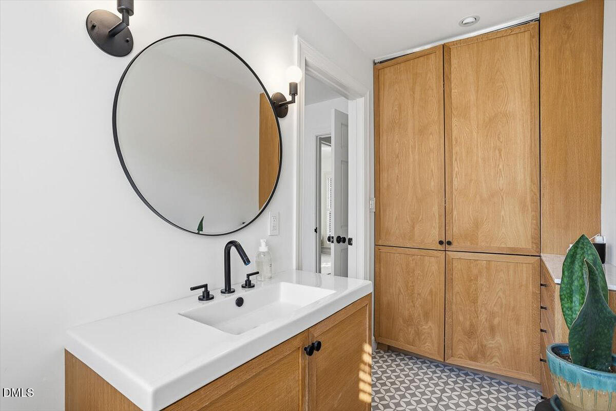 5904 Volant Drive Raleigh, NC 27609 - Photo 25 of 42 a bathroom with a sink and a mirror