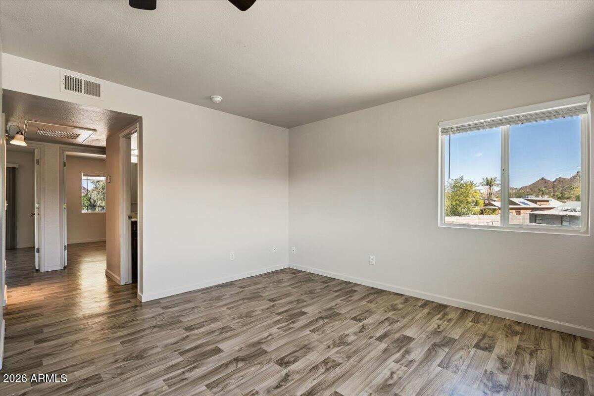 1346 East Mountain View Road, Unit 207 Phoenix, AZ 85020 - Photo 17 of 31 a view of an empty room with wooden floor and a window