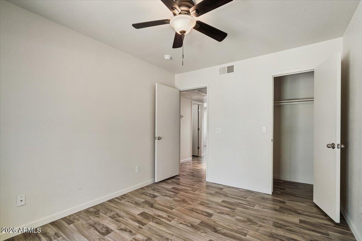 1346 East Mountain View Road, Unit 207 Phoenix, AZ 85020 - Photo 27 of 31 a view of an empty room with wooden floor