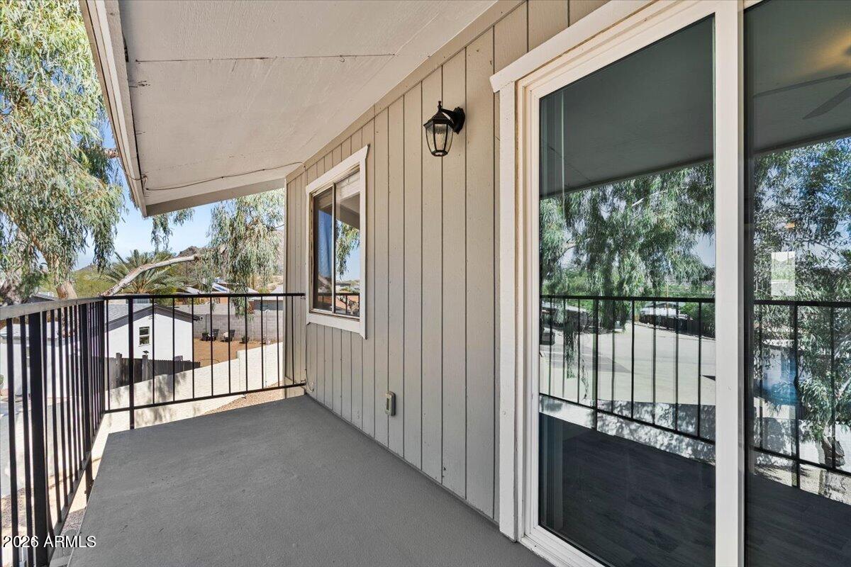 1346 East Mountain View Road, Unit 207 Phoenix, AZ 85020 - Photo 3 of 31 a view of a porch with wooden floor and outdoor space