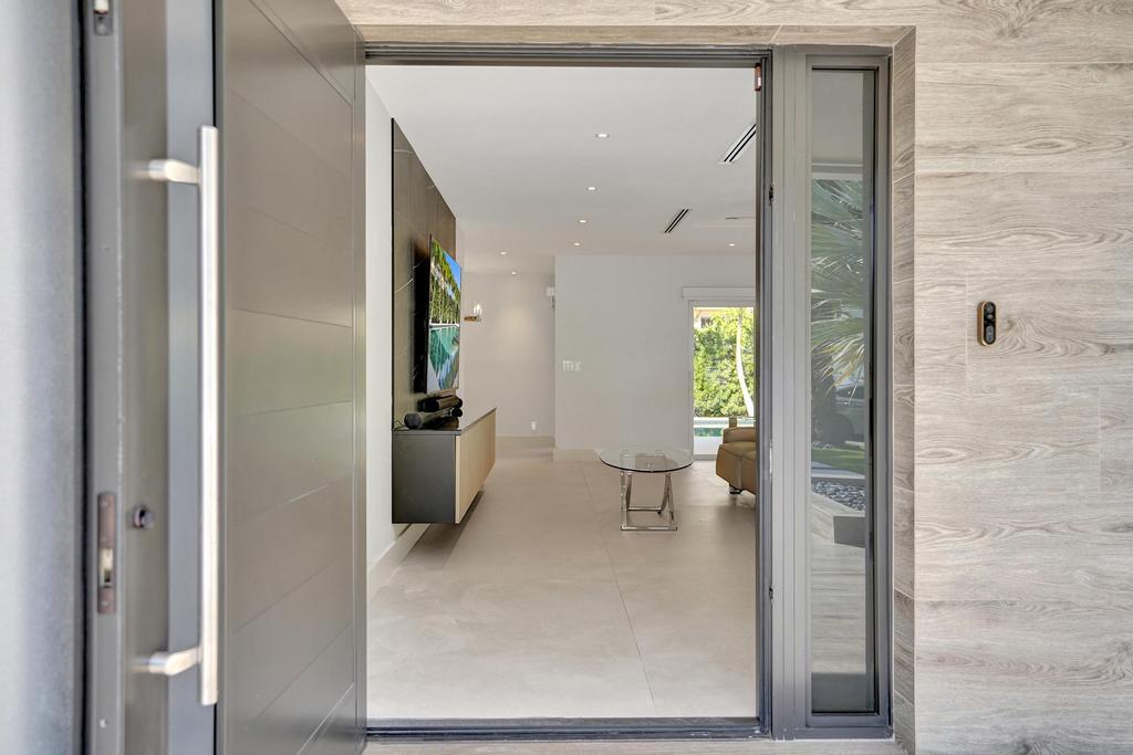 775 Northeast 39th Street Boca Raton, FL 33431 - Photo 17 of 88 a view of a hallway with toilet and a window