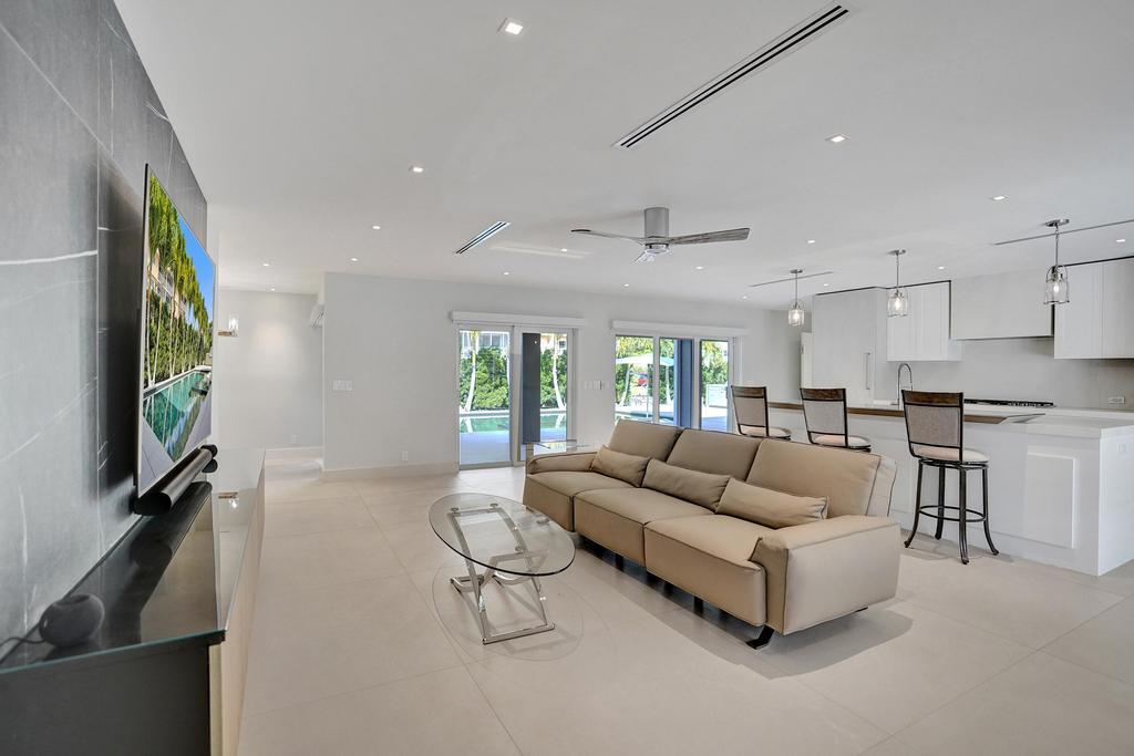 775 Northeast 39th Street Boca Raton, FL 33431 - Photo 19 of 88 a living room with furniture a flat screen tv and a large window