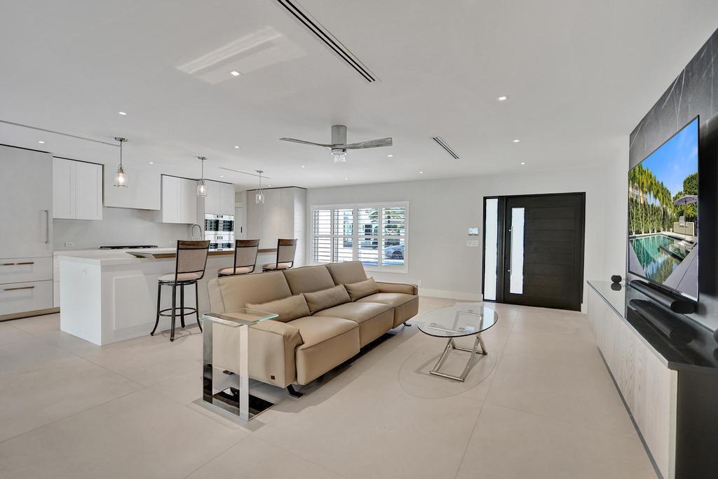 775 Northeast 39th Street Boca Raton, FL 33431 - Photo 21 of 88 a living room with furniture and a flat screen tv