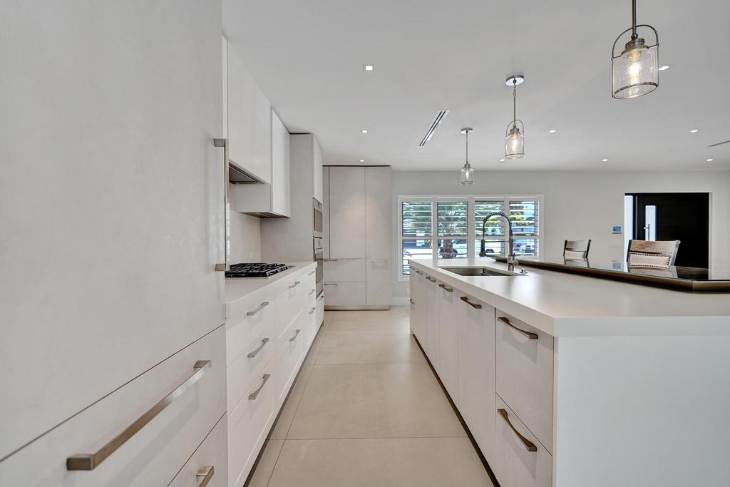 775 Northeast 39th Street Boca Raton, FL 33431 - Photo 23 of 88 a large kitchen with granite countertop a large counter top a sink stainless steel appliances and cabinets