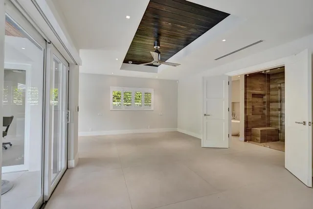 a view of empty room with wooden floor and window