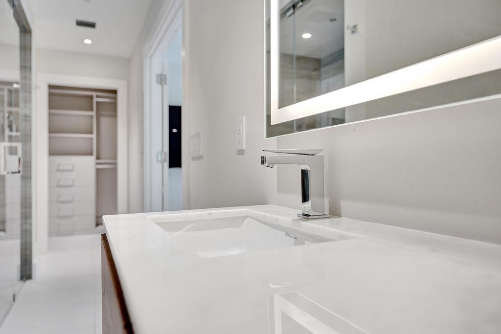 775 Northeast 39th Street Boca Raton, FL 33431 - Photo 37 of 88 a bathroom with a sink and a mirror