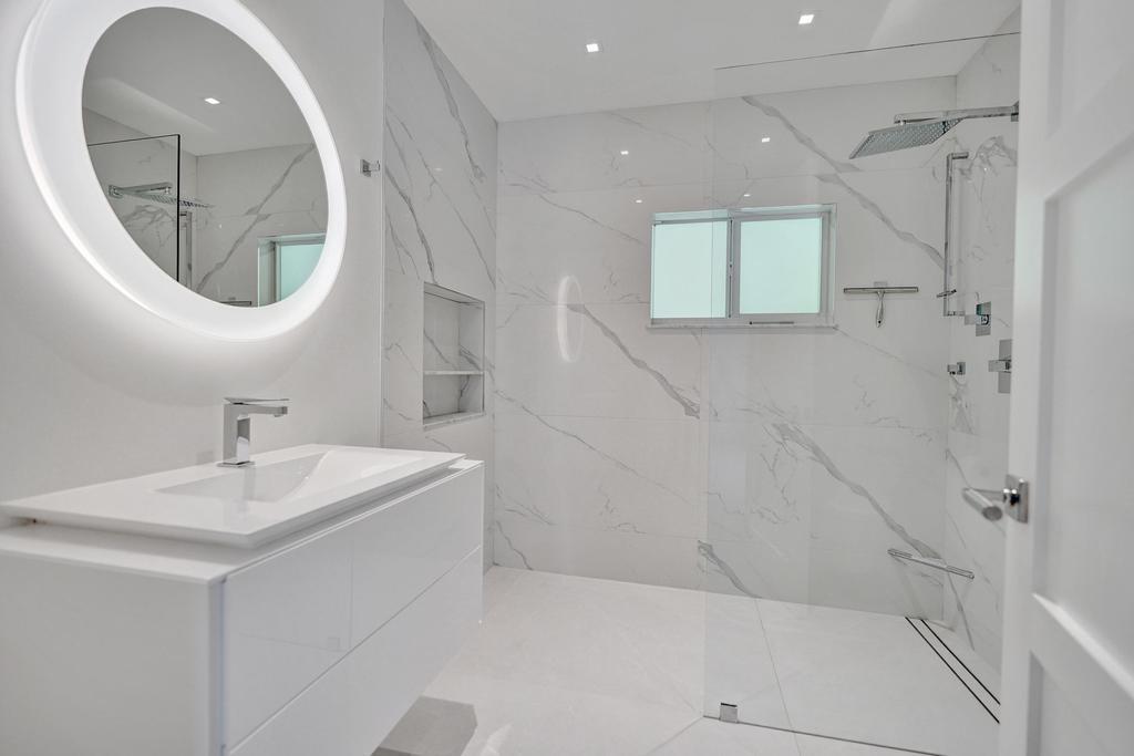 775 Northeast 39th Street Boca Raton, FL 33431 - Photo 42 of 88 a bathroom with a sink a mirror and a shower