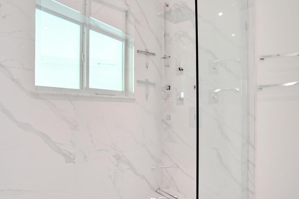 775 Northeast 39th Street Boca Raton, FL 33431 - Photo 43 of 88 a bathroom with a bathtub and a shower