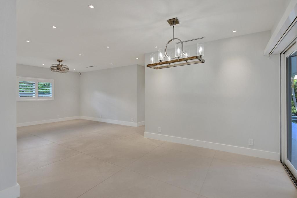 775 Northeast 39th Street Boca Raton, FL 33431 - Photo 44 of 88 a view of empty room with wooden floor and window