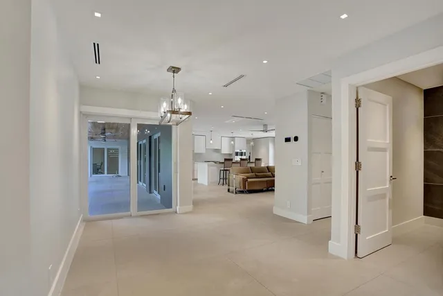 a view of house with a yard and potted plants