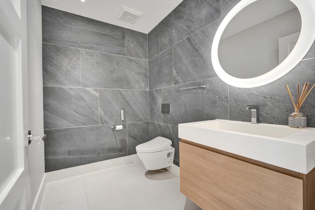 775 Northeast 39th Street Boca Raton, FL 33431 - Photo 49 of 88 a bathroom with a sink a toilet and a mirror