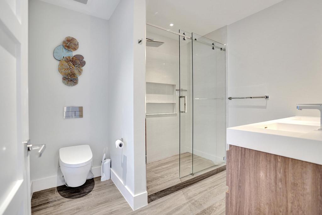 775 Northeast 39th Street Boca Raton, FL 33431 - Photo 55 of 88 a bathroom with a shower and a toilet