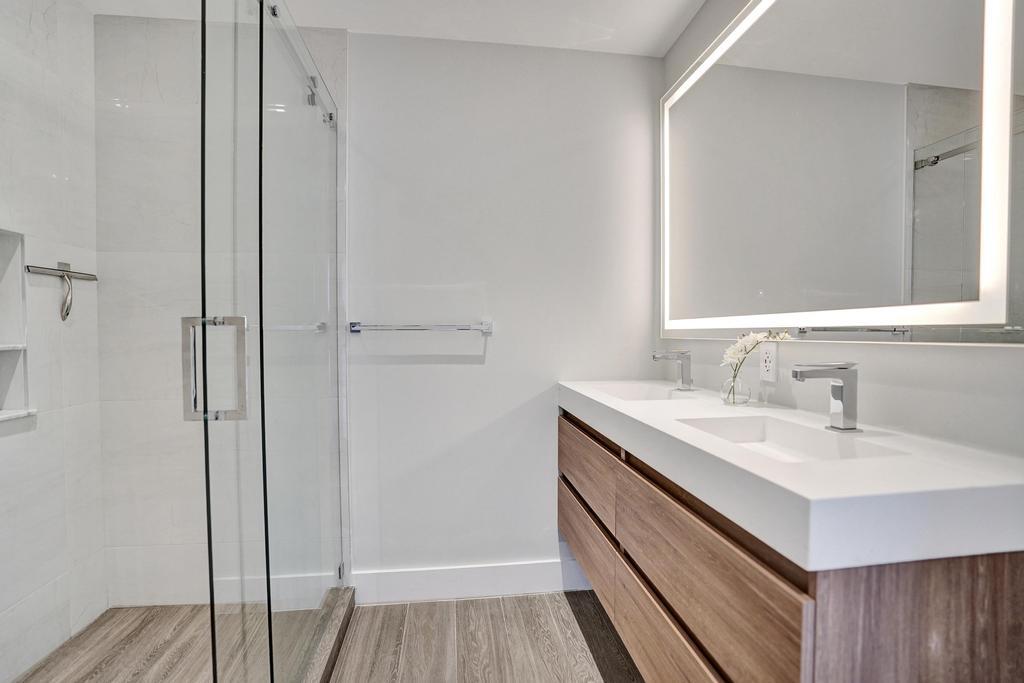 775 Northeast 39th Street Boca Raton, FL 33431 - Photo 56 of 88 a bathroom with a sink and a mirror