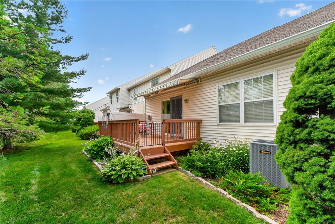 198 Park Ridge Drive Easton, PA 18040 - Photo 22 of 28 A well-maintained lawn and verdant landscaping frame a charming deck, perfect for outdoor relaxation.
