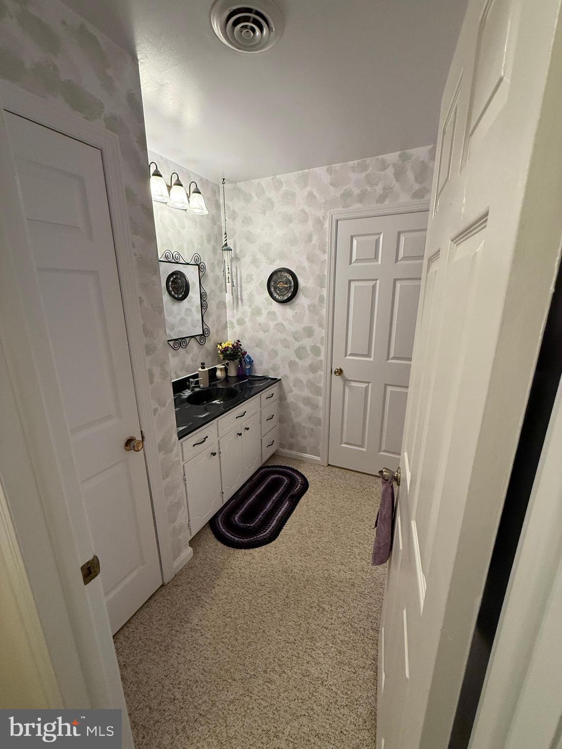 10984 Old Forge Road Waynesboro, PA 17268 - Photo 32 of 41 a bathroom with a granite countertop sink a toilet a mirror and shower