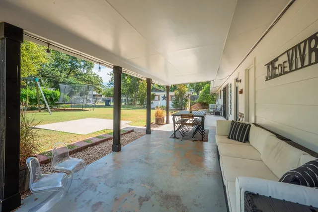 a living room with furniture and a floor to ceiling window