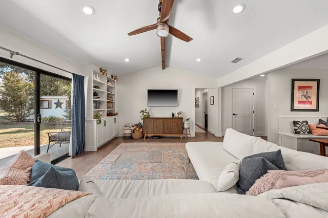 a living room with furniture and a large window