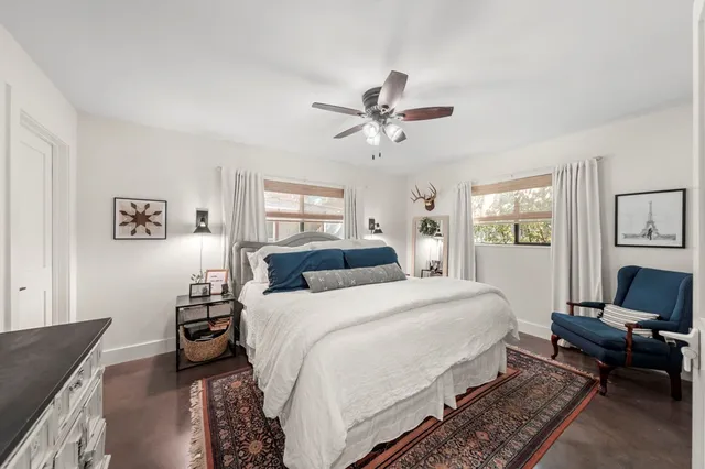 a bedroom with a bed couch and a window