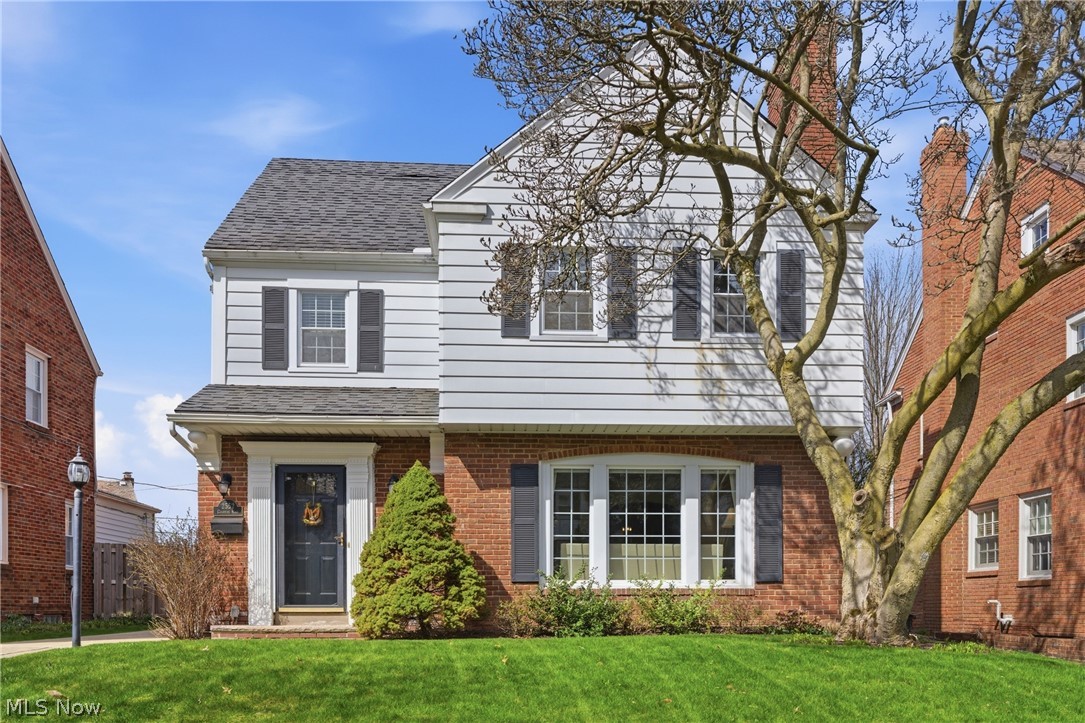 2552 Channing Road Cleveland, OH 44118 - Photo 1 of 33 Front exterior of Colonial home with brick and white siding, featuring a magnolia tree.