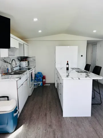 a utility room with sink dryer and washer