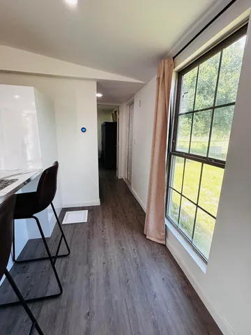 a view of room with furniture and wooden floor
