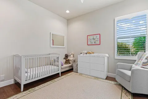 a view of a bedroom with furniture and windows