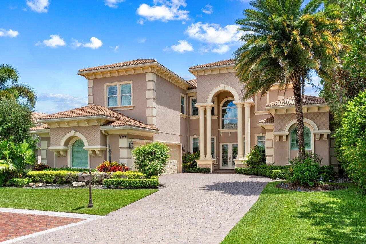 6464 Bellamalfi Street Boca Raton, FL 33496 - Photo 22 of 32 a front view of a house with a garden