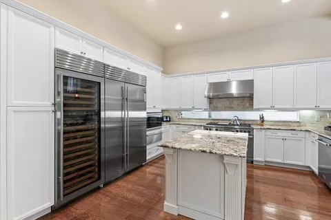 a kitchen with kitchen island granite countertop stainless steel appliances and counter space