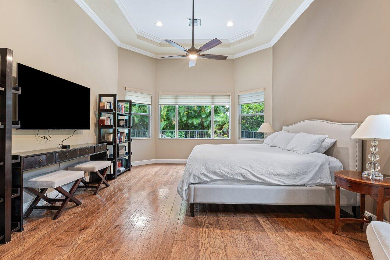 6464 Bellamalfi Street Boca Raton, FL 33496 - Photo 8 of 32 a bedroom with a bed and a flat screen tv
