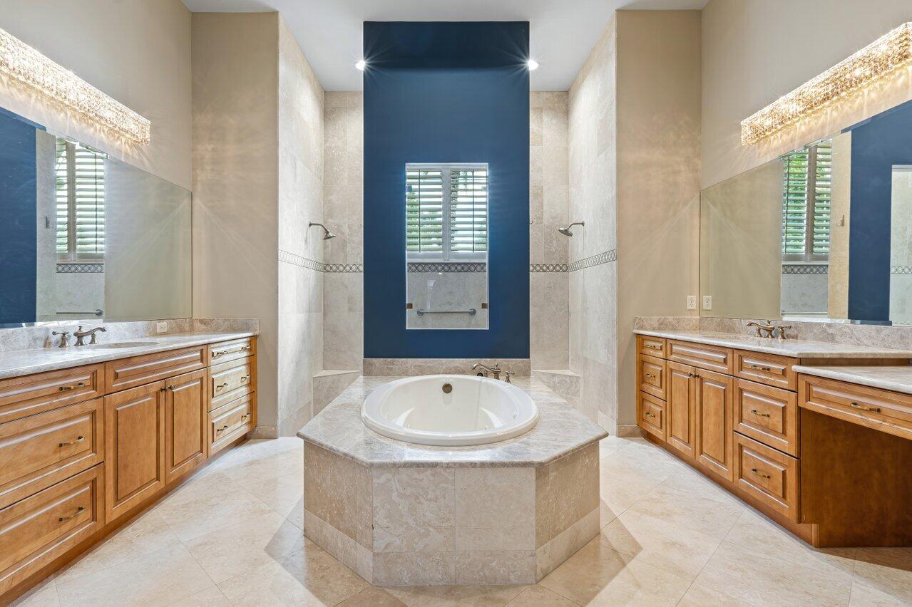 6464 Bellamalfi Street Boca Raton, FL 33496 - Photo 9 of 32 a spacious bathroom with double vanity sink a mirror a bathtub and window