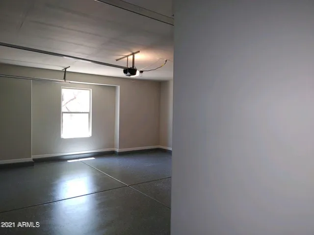 a view of wooden floor windows and in an empty room