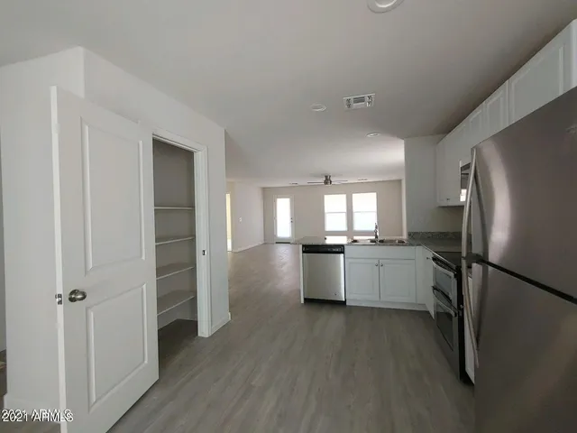 a kitchen with a refrigerator and a sink